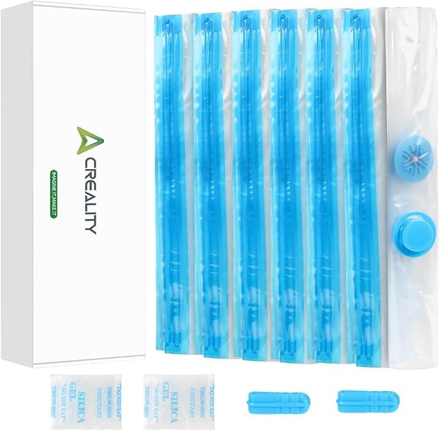Creality-Box neben gefalteten Beuteln mit blauen Zippern, einem runden Ventil mit Kappe, zwei Silicagelbeuteln und zwei blauen Zipperschiebern